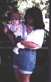 [Lyra in her cool baseball cap with Mom]